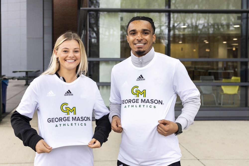 two student-athletes in new uniforms