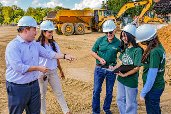 FCED officials and representatives from the business school review the conceptual layout of the Northfax West development project.